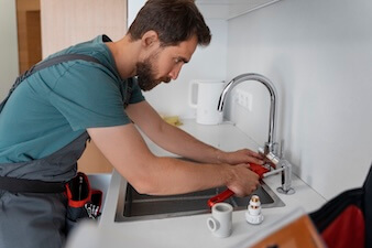 Kitchen Faucet Repair Plumber Repairing Faucet in Kitchen