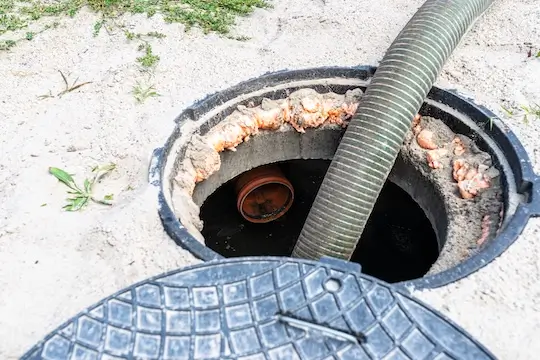 four-inch-suction-pipe-inserted-into-home-septic-tank-suction-household-wastewater