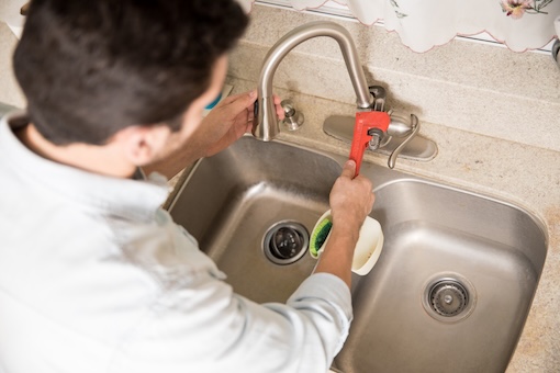 plumber fixing a faucet Kitchen Faucet Installation Service